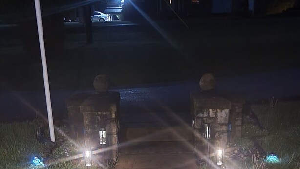A pathway with evenly spaced, illuminated posts on either side, leading to a building with a lit entrance. - Quiet Space with Spacious Yard for Parking in Nice Community  (East Millsboro)