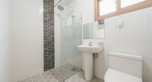 A bathroom with a glass shower enclosure, a white sink, and a toilet. - Today Seogwipo (Seogwipo)