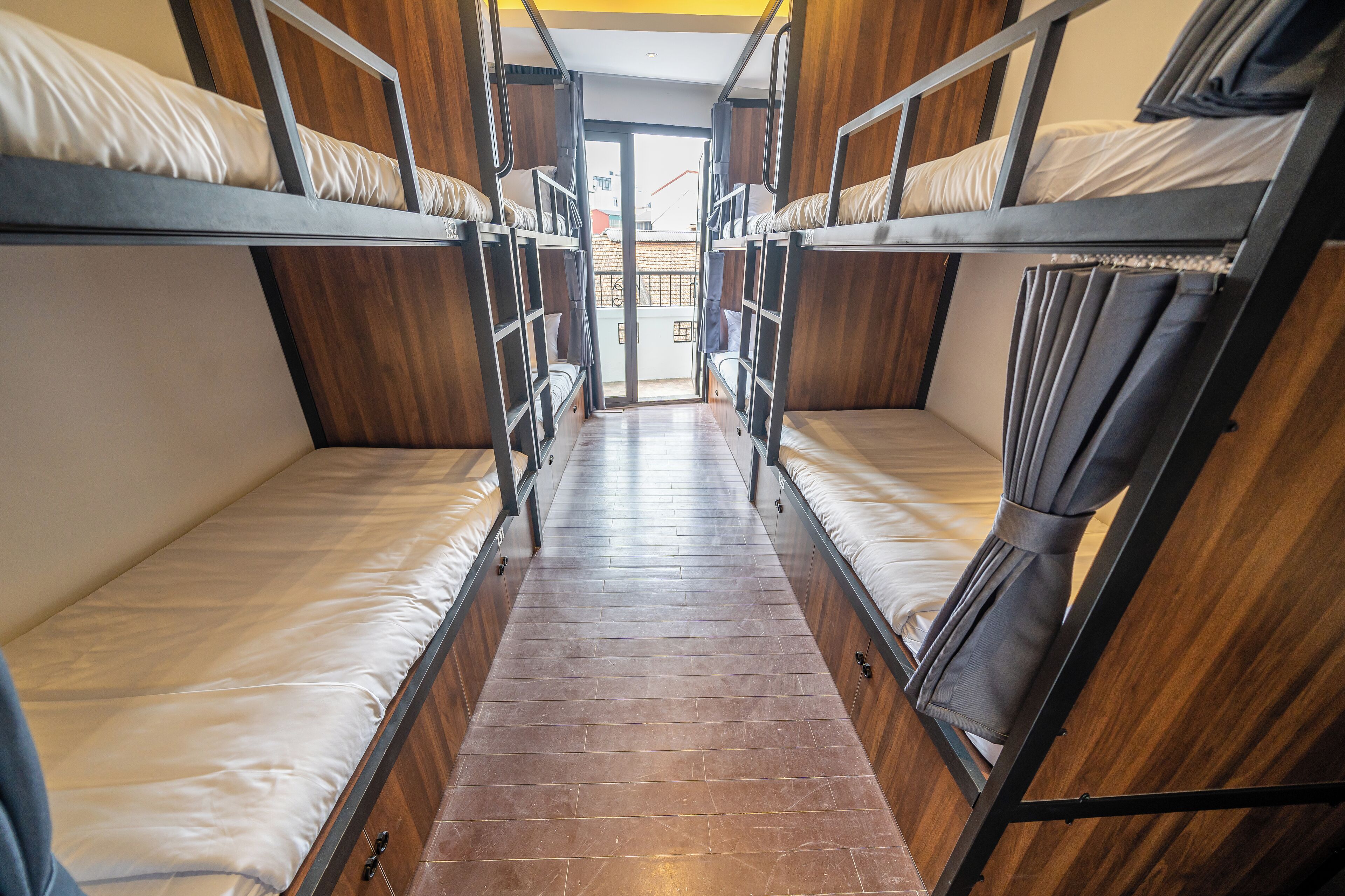 A bunk bed room with wooden walls and a tiled floor.