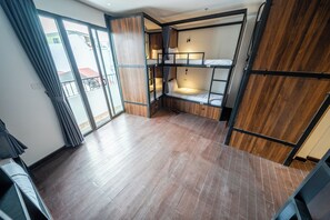 A room with a wooden floor, a bunk bed, and a sliding door. - Mad Monkey Hanoi - Hostel (Hanoi)