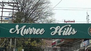 A busy street scene with a prominent sign for "Murree Hills". - Al Marhaba Inn Hotel (Murree)