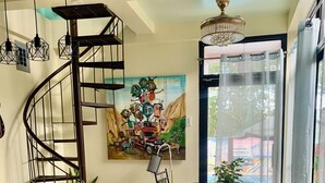 A modern kitchen with a marble countertop, a spiral staircase, and a dining area with a table and chairs. - Your Private Resort with Pool - A's Place! (Valencia)