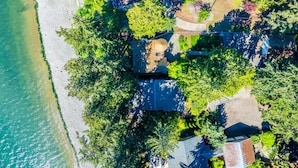 An aerial view of a coastal residential area with houses, trees, and a beach. - Fairyland Cottage: Waterfront+Hot Tub+Beach+Clam (Poulsbo)
