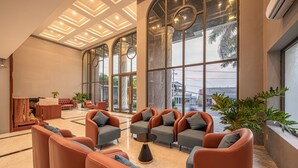 A spacious lobby with leather sofas, a coffee table, and large windows offering views of the outside. - TAHITI CENTRAL HOTEL (Phu Quoc)