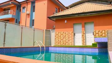 Enjoy a refreshing swim in the pool surrounded by a tiled deck.