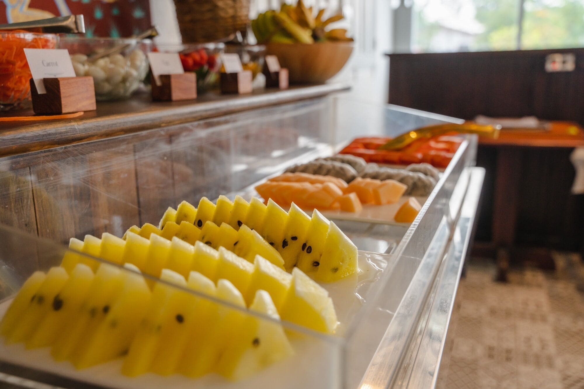 A buffet with various fruits and vegetables.