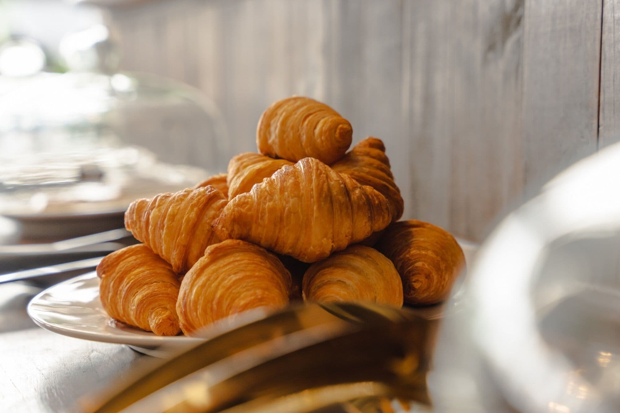 A stack of croissants on a plate.