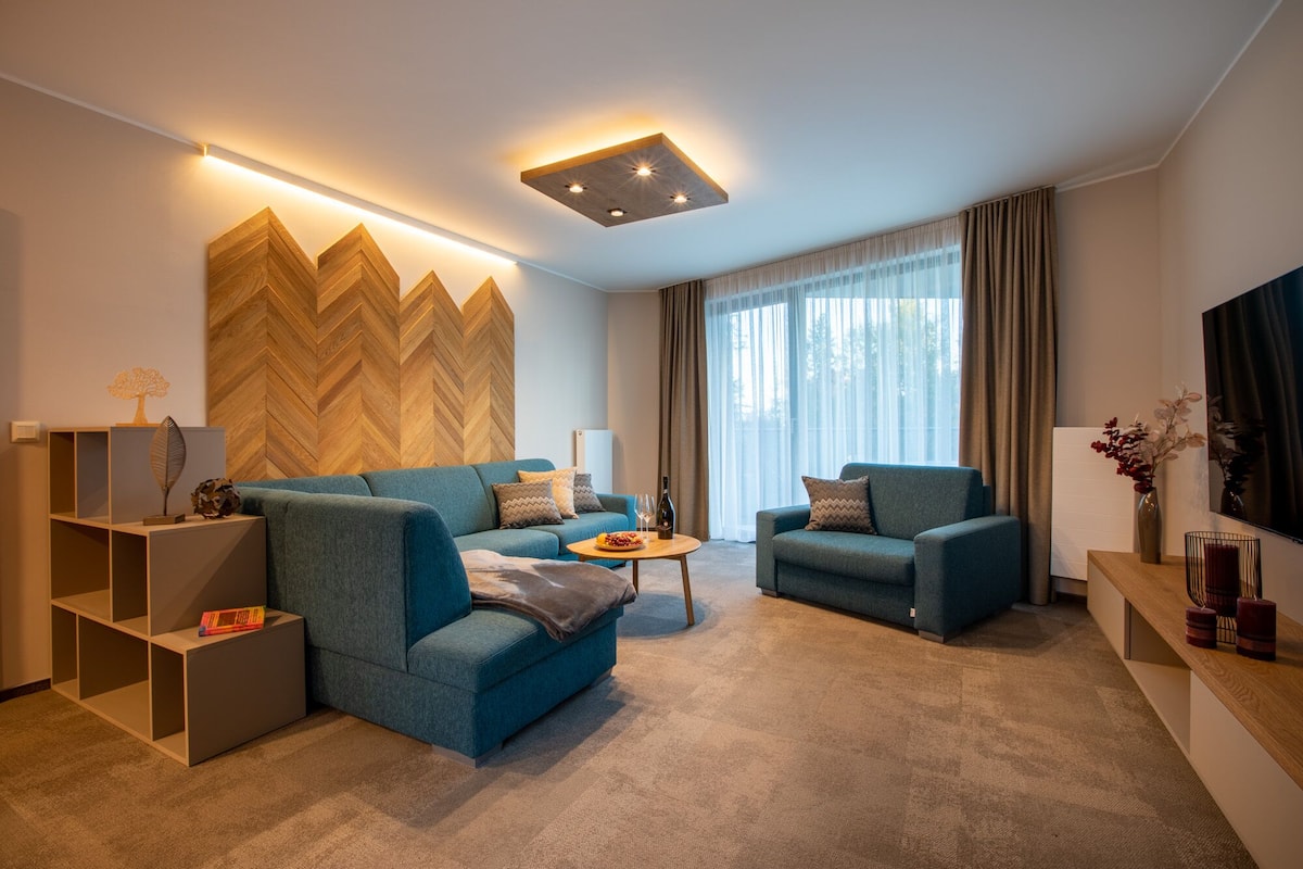 A modern living room with two sofas, a coffee table, and a TV.