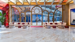 A spacious lobby with a high ceiling, large windows, and a modern interior design. - voco Monaco Dubai Heart of Europe by IHG (Dubai)
