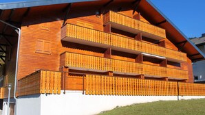 A multi-story wooden building with balconies.