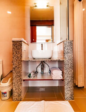 A bathroom with a sink, mirror, and towel rack. - Magnificent Hotel (Kathmandu)
