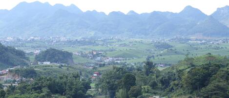 A mountainous landscape with terraced fields and scattered buildings.