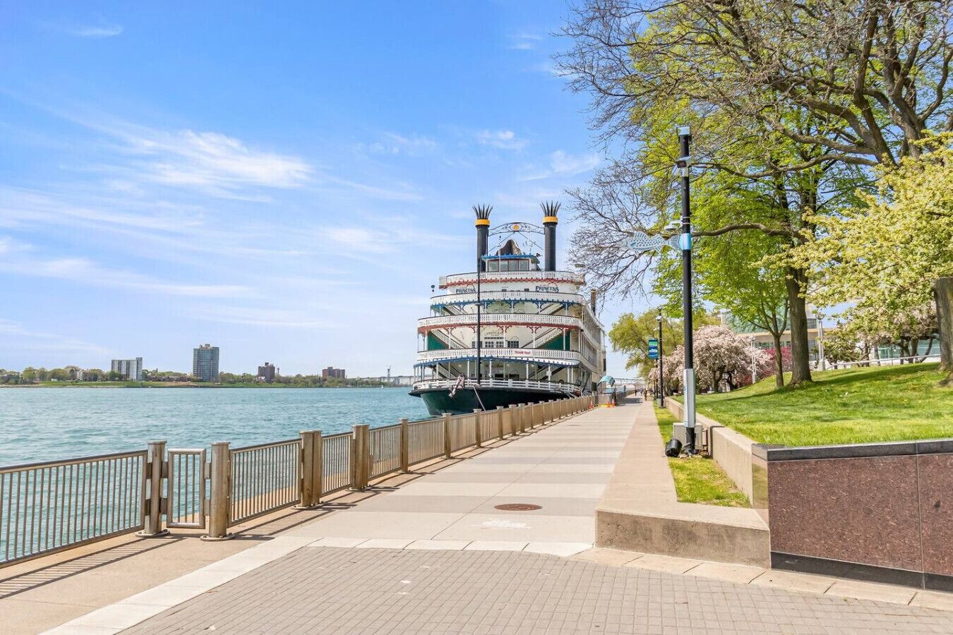 A riverboat with a multi-deck design, a covered upper deck, and a lower deck with a visible cabin structure.