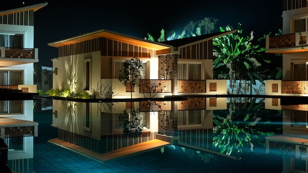 A modern hotel with a pool reflecting the buildings. - Hotel Sonar Bangla Mayapur (Krishnanagar)