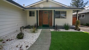 A single-story house with a front door, a small porch, and a well-maintained lawn. - LuxoStays| Sleep 14! Spacious 6BR Nr Napa(10 Bed) (Fairfield)