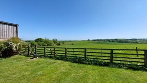 A rural landscape with a wooden fence, a gate, and a barn. - Meadow cottage- two bedrooms both ensuite and all on one level. (Rushyford)