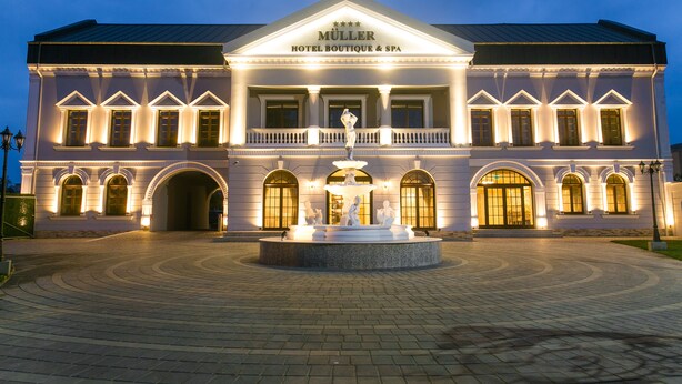 A grand hotel with a central fountain, arched windows, and a symmetrical facade. - Muller Hotel Boutique&Spa (Galati)