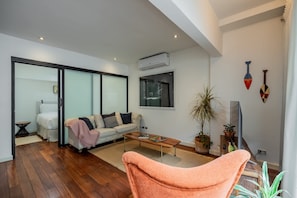 A modern living room with a sofa, coffee table, and a chair. - w* | Charming 2BR in Casco Antiguo (Panamá)