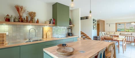 Fridge, dishwasher, coffee/tea maker, cookware/dishes/utensils