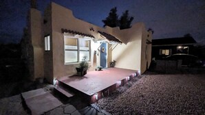 A house with a porch, a door, and a small garden area. - Hot Summer Deals Cute Clean Quiet Dog Friendly (Phoenix)