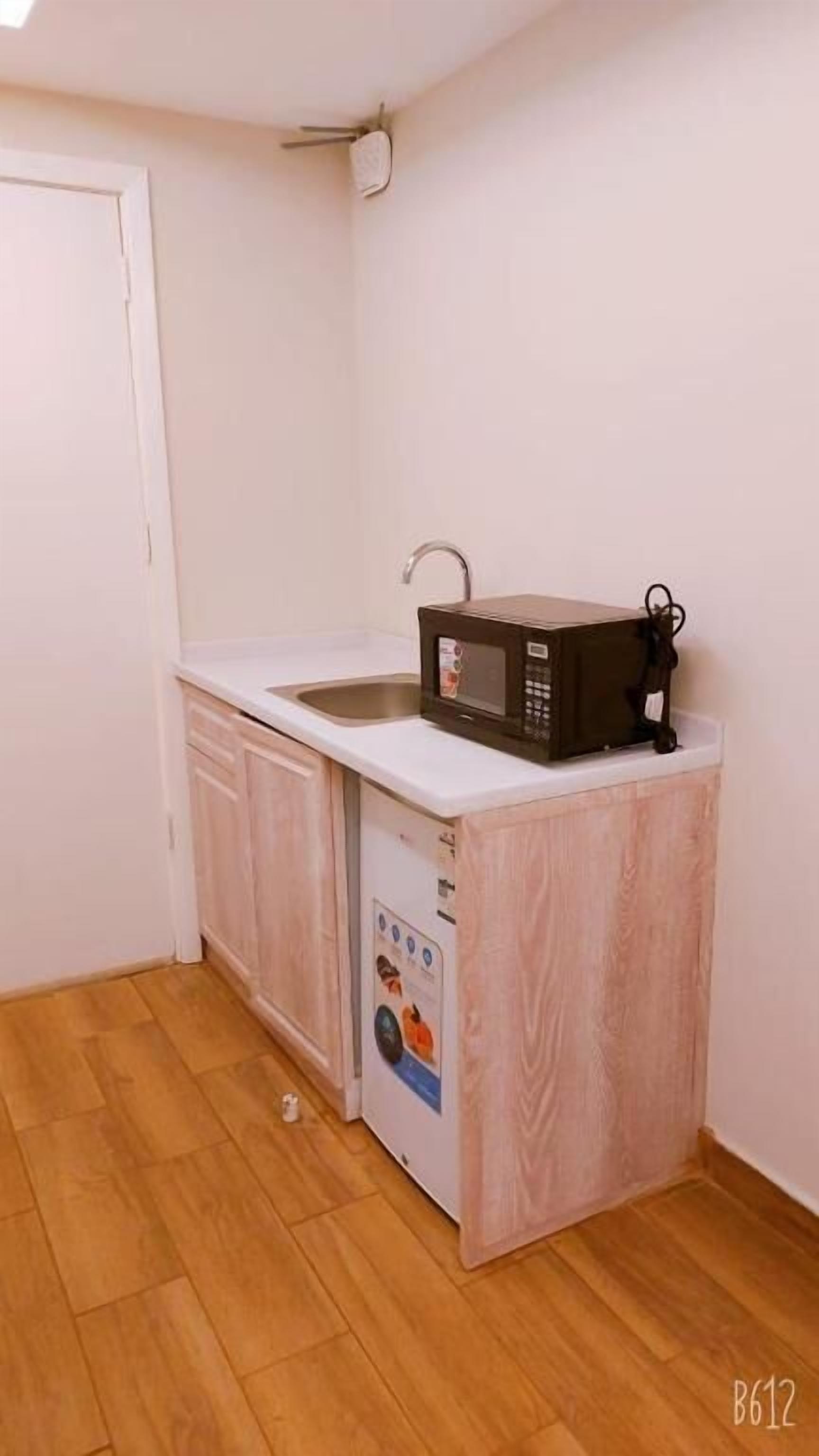 Mini-fridge, microwave, oven, paper towels