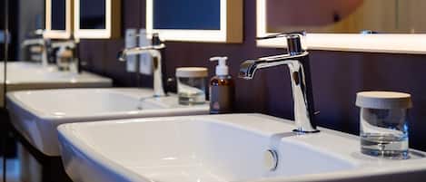 A modern bathroom with two sinks, each with a mirror above.