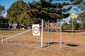 A rural setting with a sign for 'Blackiron' and a 'Crest' sign indicating a one-lane road.