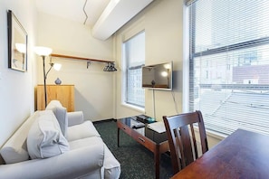 Relax in this stylish room with a sofa, dining table, and flat-screen TV.