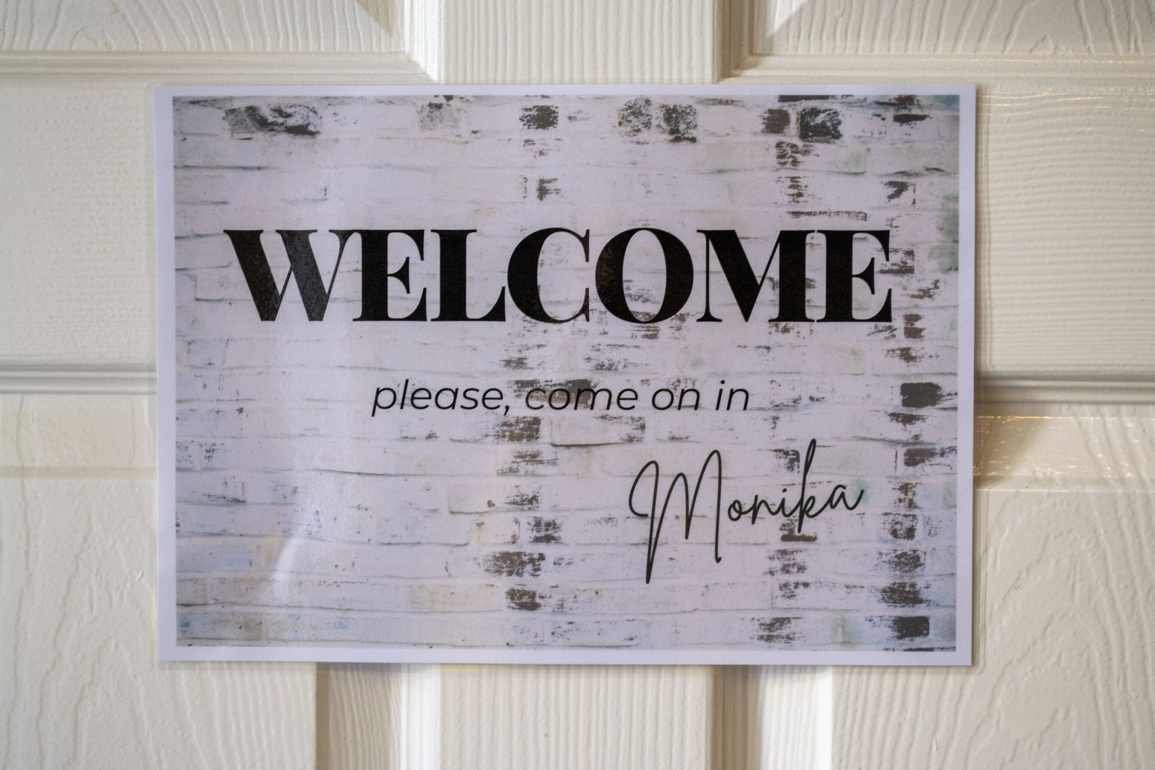 A welcome sign with the text "WELCOME please come in" and a signature.