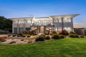 A modern two-story house with a flat roof, large windows, and a well-maintained garden. - Waterline Ocean Front Luxury  Bells Beach (Jan Juc)
