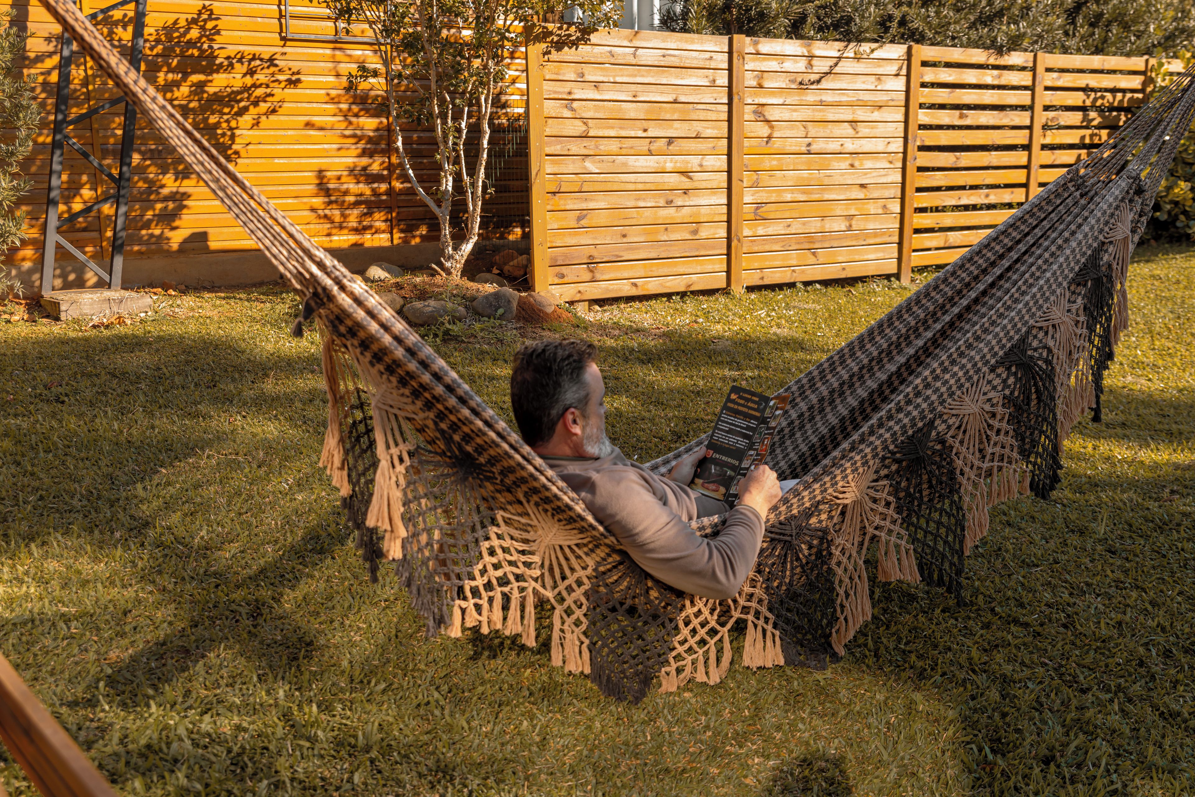 A person relaxing in a hammock outdoors.