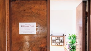 A wooden door with a sign reading "El Dorado Prati" and a small window. - El Dorado Prati (Rome)