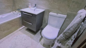 Bathtub, hair dryer, towels
