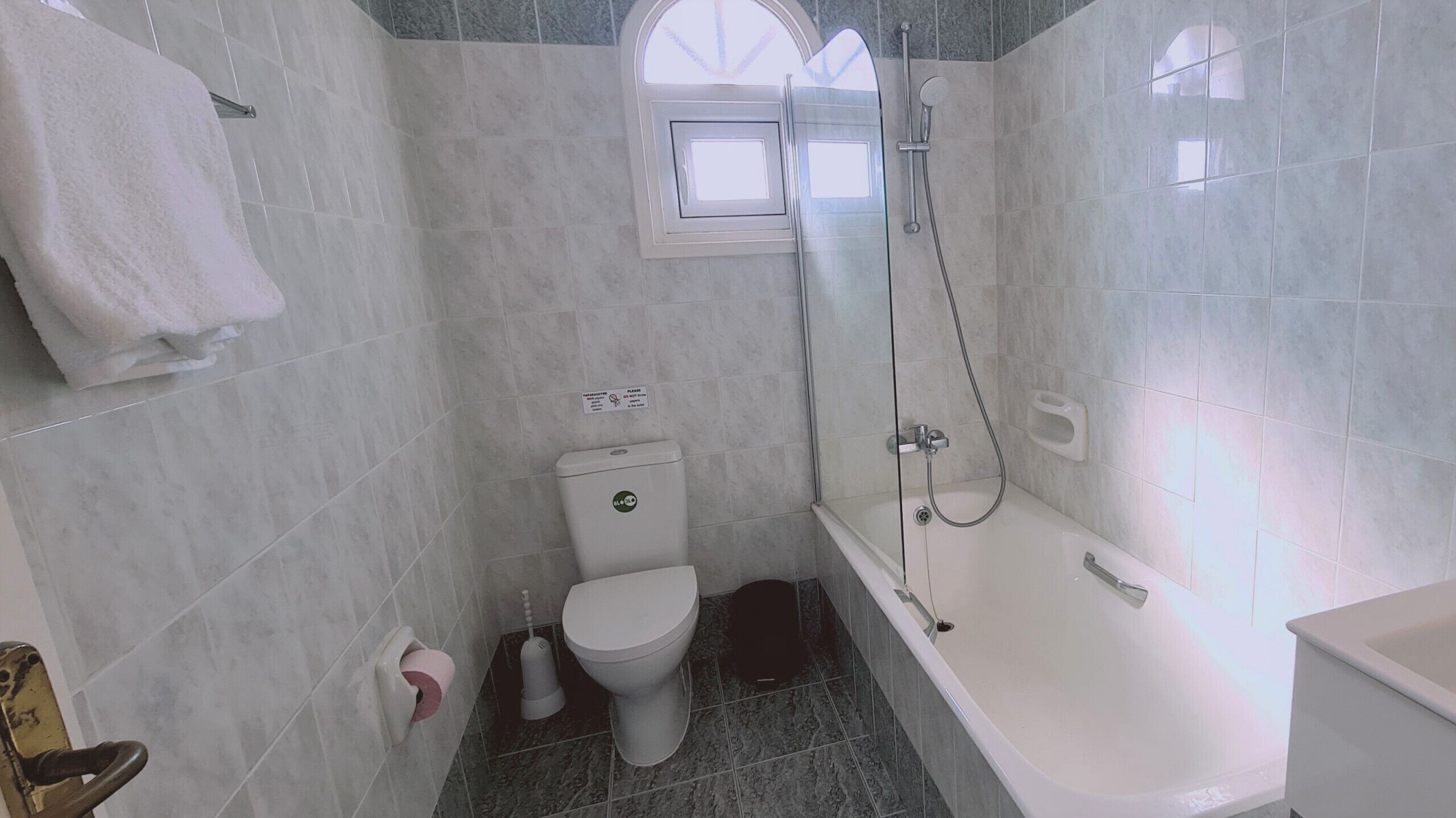 A bathroom with a toilet, a shower, and a bathtub.