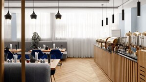 A modern dining area with a long wooden counter, multiple seating options, and pendant lighting. - Aveon Hotel (Abuja)