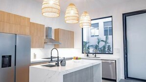 A modern kitchen with a central island, stainless steel appliances, and pendant lighting. - Ocean view luxury Villa, Private Pool 4BD 8PPL (Provincia de Los Santos)