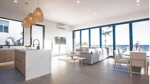 A modern interior with a kitchen, living area, and large windows overlooking the ocean. - Ocean view luxury Villa, Private Pool 4BD 8PPL (Provincia de Los Santos)
