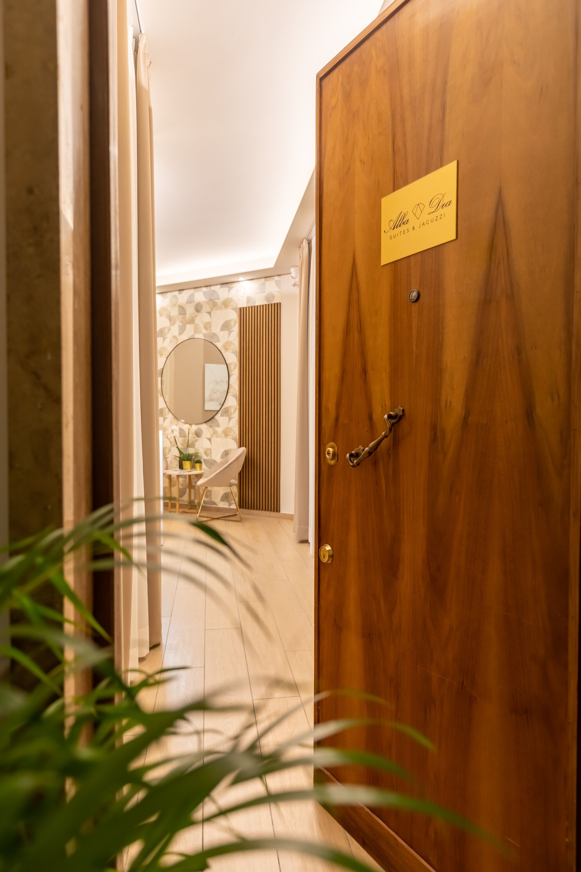 A wooden door with a sign reading "Alfa & Gia Suites & Jacuzzi".