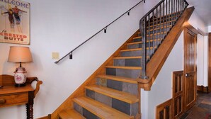 A staircase with wooden steps and a metal railing, leading to a door. - In the Town of Crested Butte! Near parks, trails, shops & restaurants (Crested Butte)