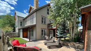 A two-story house with a patio area featuring outdoor furniture and a fire pit. - In the Town of Crested Butte! Near parks, trails, shops & restaurants (Crested Butte)