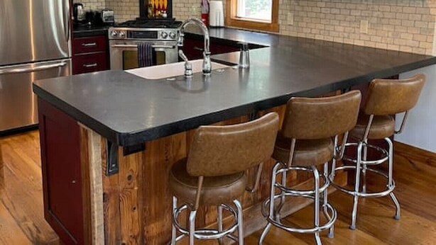 A kitchen with a large island, stainless steel appliances, and wooden bar stools. - In the Town of Crested Butte! Near parks, trails, shops & restaurants (Crested Butte)