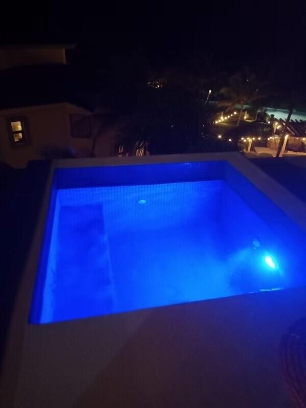 A swimming pool at night with blue lighting. - Casa Paraiso Caribe - stunning views! (Isla Mujeres)