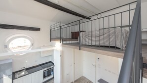 A compact, modern apartment with a kitchen, a dining area, and a small balcony. - Zannetti 401 Top floor (Firenze)