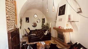 Una sala de estar acogedora con chimenea, un sofá y una mesita de centro.