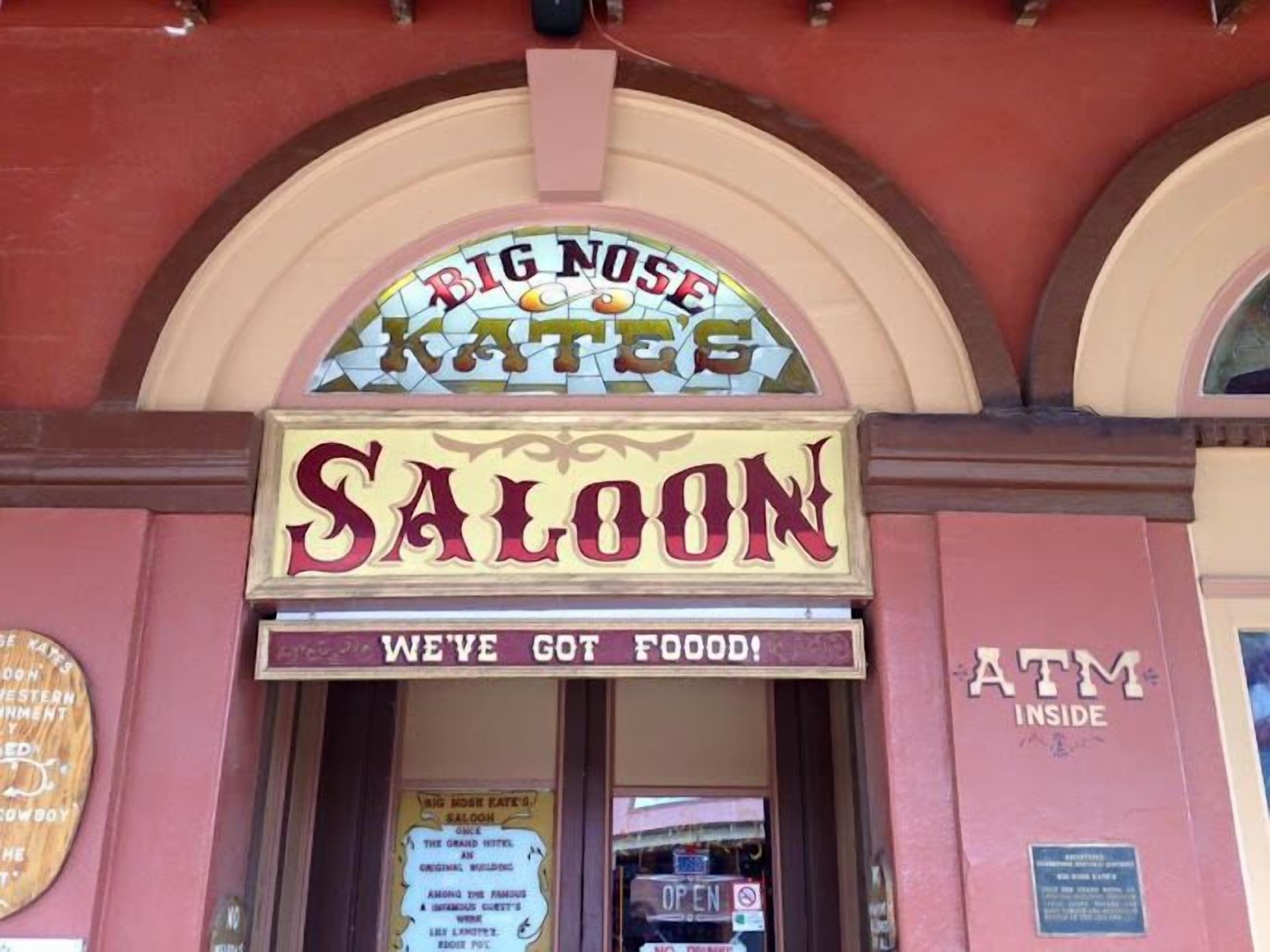 A saloon with a sign reading "BIG NOSE KATES SALOON" and "WE'VE GOT FOOD!"