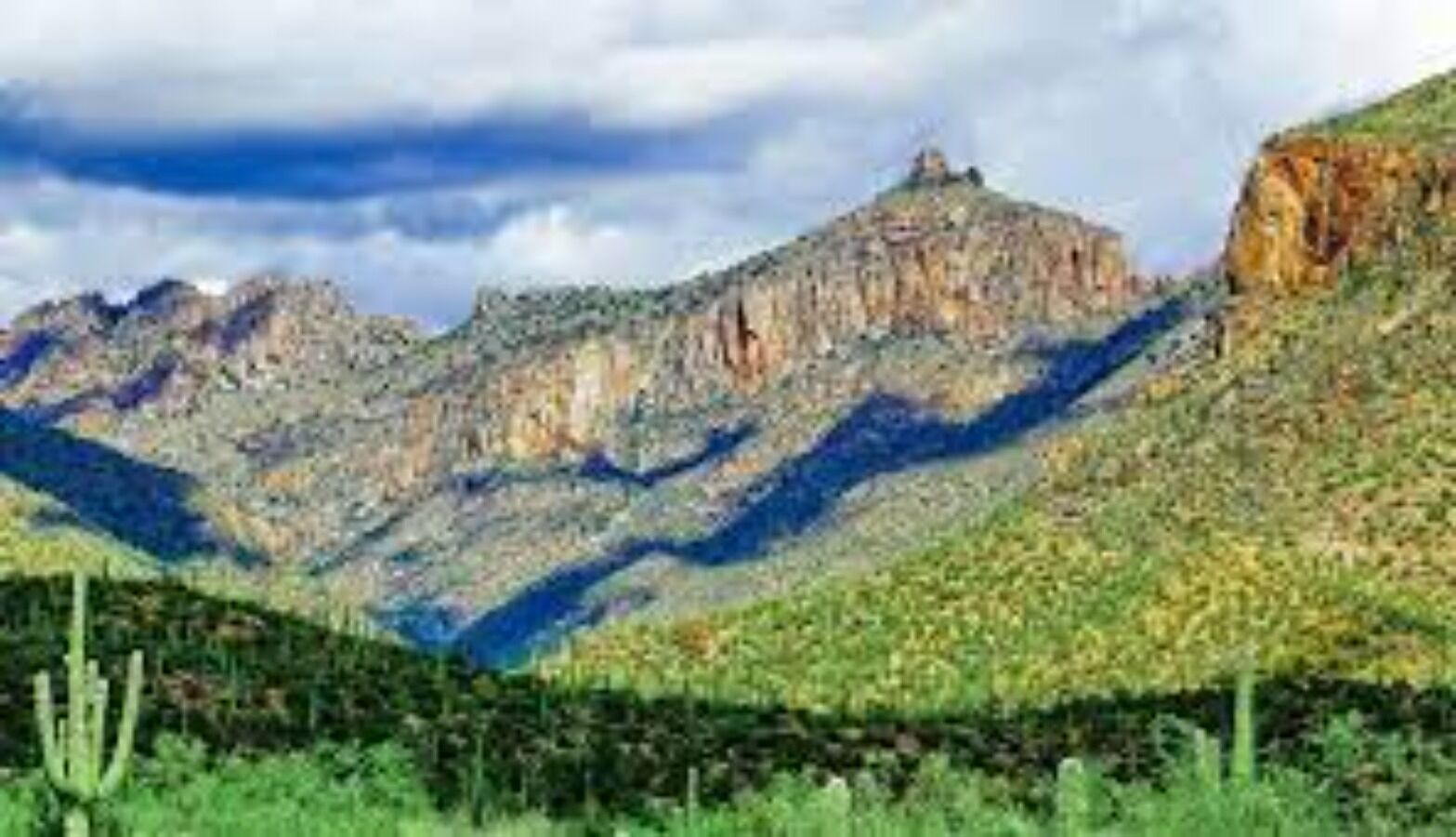 A mountainous landscape with rocky terrain and sparse vegetation.