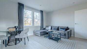 Basic Apartment, Multiple Beds | Living area | TV