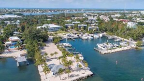 An aerial view of a marina with boats docked, surrounded by residential buildings and greenery. - Marathon Key Beach Club 2 bed a202 B202 C201 C202 (Marathon)