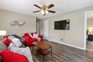 Relax in this cozy space with a flat-screen TV and comfortable seating area.