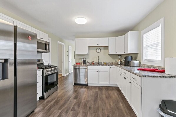 Enjoy cooking in this well-equipped kitchen with a refrigerator, oven, and microwave.